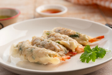 Thai boiled Wonton wrapped with shrimp and minced pork in white plate.appetizer food