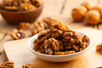 Walnut kernel and whole walnuts on a plate.Healthy Fats,Support weight management.
