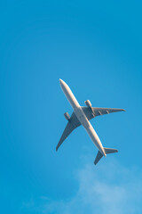 An airplane flying under blue sky