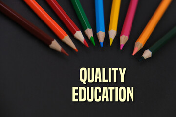 colorful pencils on black background with text of QUALITY EDUCATION. no. 4 goals of SDG - sustainability development goals concept. 