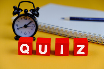 the words Its Quiz Time on black background with multiple colors pencils. the concept of answering...