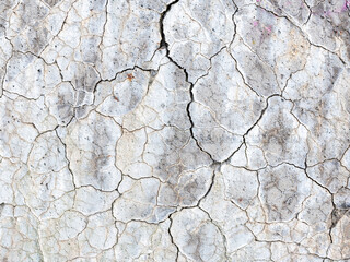 abstract line pattern on white painted part of conrete with cracks