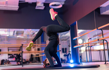 Enthusiast doing advanced indoor yoga. A fitness enthusiast showcases skillful balance in a...
