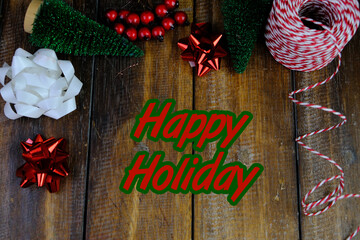 Season's greetings scene. Top view of Christmas decorations, balls, rustic star, holly berries,...