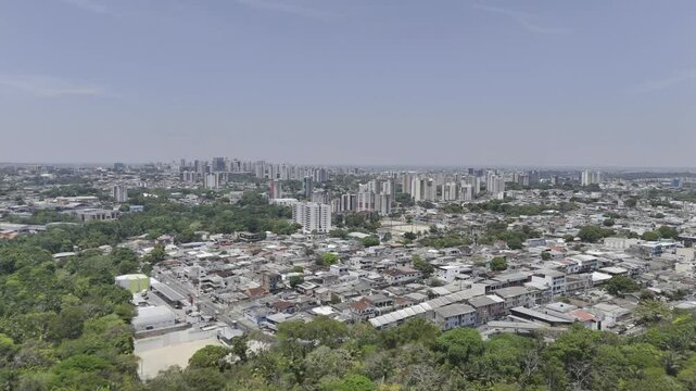 Drone flies south over Parque Municipal do Mindu on sunny afternoon in Manaus, Amazonas, Brazil
