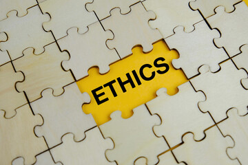 Ethics words on wooden puzzle with letters, ethics moral philosophy concept, business and management concept