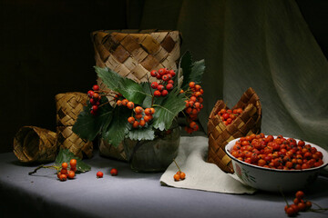 Still life with hawthorn against the background of a birch bark box