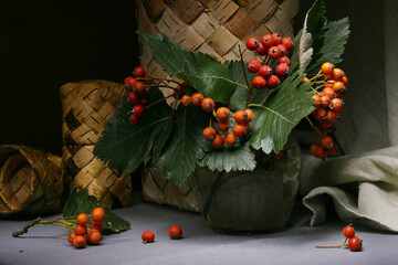 Still life with a bouquet of hawthorn against the background of a birch bark box