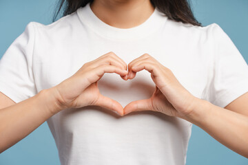 Fototapeta premium Woman making heart shape with hands showing love