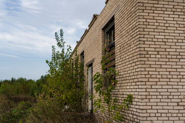 Corner of an old, abandoned, brick store building in the village