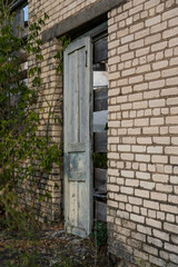 The doors of the back entrance to an abandoned, rustic store