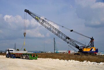Concrete pile construction of new building at construction site. Square pile foundation for soil