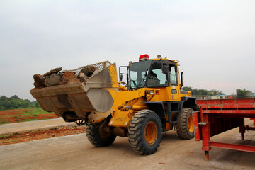 Fototapeta premium Bulldozer loader machine during earthmoving.Heavy equipment machine on construction site