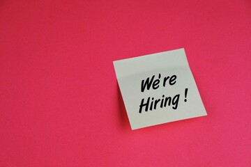 text of WORK WITH US with view of a workplace with a cup of coffee, on a wooden table. Education, business, Financial and office concept.