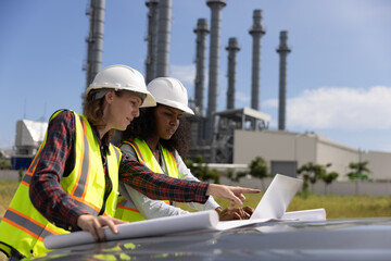 Right data drives your business to accomplish your goals. Super Power Girl collaboration at a thermal power plant work with a blueprint to follow up on building project 