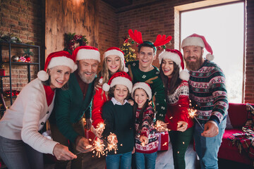 Portrait of friendly peaceful family have fun bengal lights gather celebrate new year xmas flat indoors