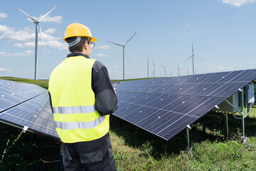 Engineer with digital tablet on a background of solar panels
