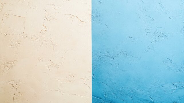 A textured wall split vertically into beige and blue sections, evoking contrast and balance, Ideal for design, decoration, or artistic backgrounds,