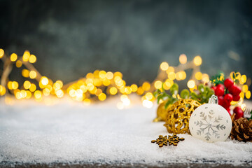 Christmas Holiday background with snow, fir tree and decorations with christmas light behind....