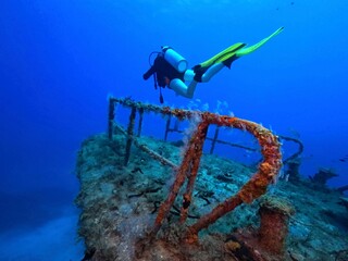Vivid marine life, blue sea, wreck and scuba diver. Travel photo, diver and seascape. Deep blue...