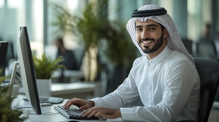Smiling young middle eastern businessman sitting at worktable at modern office typing on computer keyboard sending emails to his business partners working on marketing research copy sp : Generative AI
