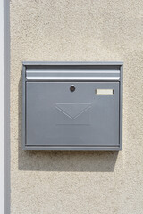 A section of an exterior wall wall with a metal mailbox