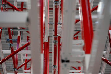 Close up photograph of sprinkler system head inside racking system of manufacturing plant