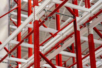 Close up photograph of sprinkler system head inside racking system of manufacturing plant