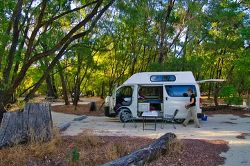 Fotobehang Middle aged woman camping with a small camper van on a camping ground close to Perth, Western Australia. Yalgorup National Park  © HansWismeijer