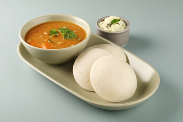 Traditional breakfast of South India IDLY served with sambar Chutney in a ceramic plate