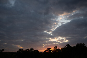 yellowish-blue evening sky against a backdrop of big clouds