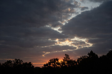 yellowish-blue evening sky against a backdrop of big clouds
