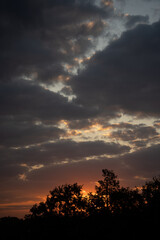 yellowish-blue evening sky against a backdrop of big clouds