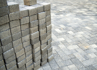 Paving stones are stacked on a newly paved area