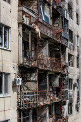 Closeup view of ruined facade of house.