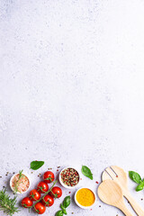 Wooden cutlety set, basil leaves and spices on gray concrete background with copy space for your...