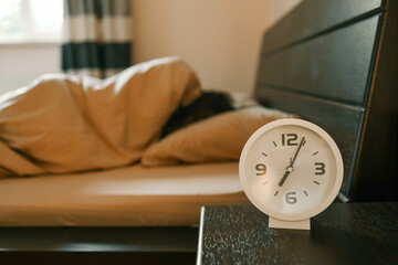 Alarm clock and person in the background, sleep