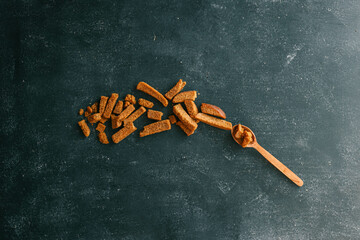 Wooden bowl filled with crispy rye croutons placed on a burlap cloth, creating a rustic snack...