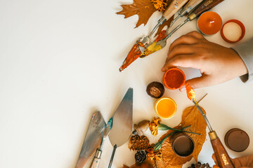 Creative autumn art activity with paint and natural materials like pine cones, acorns, and chestnuts, crafting seasonal decorations