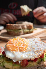 Toasted bread with tomato, avocado and egg. Photo of breakfast for an institution, Delicious food. Culinary concept.