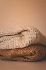Fototapeta premium A stack of knitted sweaters, cozy autumn