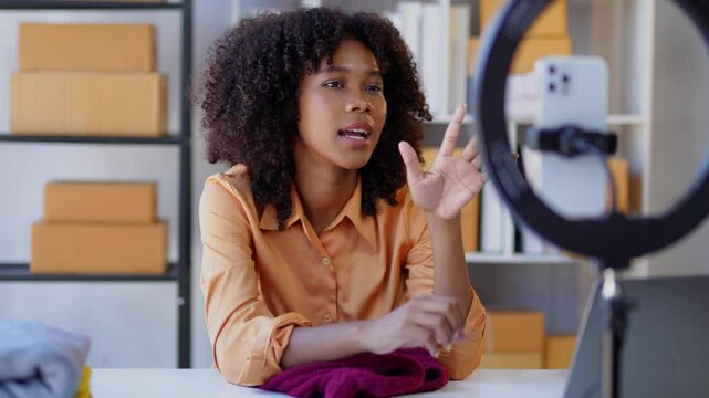 Young entrepreneur records a product review using a smartphone, showcasing authentic engagement with her audience