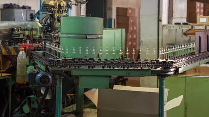 Conveyor line that puts tungsten filament on tube wires.