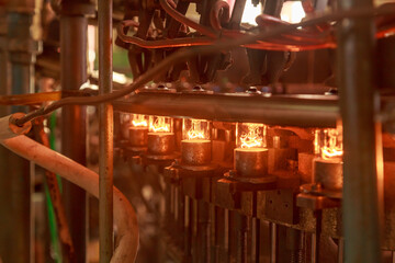 Processing line of light bulb factory with special equipment for working with hot melting glass...