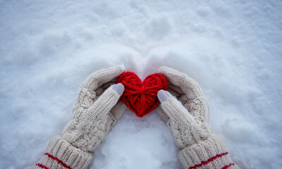 Winter Themed Marketing, Red Knitted Heart Held by Gloved Hands in Snowy Environment, Cozy, Warmth, Winter, Love, Holidays, Handmade, Cold Weather, Valentine's Day, Festive