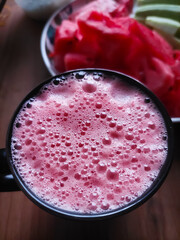 Watermelon juice in a black mug