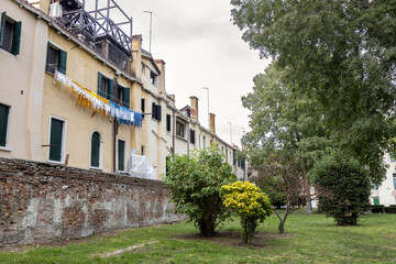 Savorgnan Park in Cannaregio, Venice, lined by residential buildings with clotheslines in the...