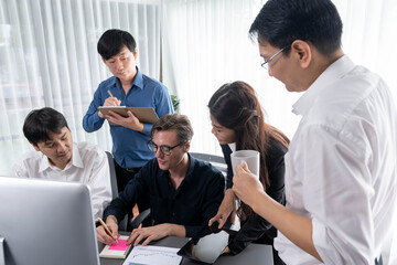 Group of diverse office worker employee working together on strategic business marketing planning in corporate office room. Positive teamwork in business workplace concept. Prudent