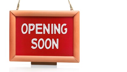 opening soon words sign written on red rectangular banner. Conceptual symbol announcing a business will be open for business in near future. isolated on white background with copy space.