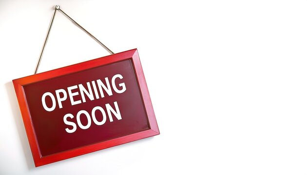 opening soon words sign written on red rectangular banner. Conceptual symbol announcing a business will be open for business in near future. isolated on white background with copy space.